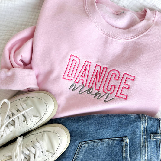 Light Pink crewneck sweatshirt with embroidered dance mom design in pink and grey threads styled with jeans and sneakers