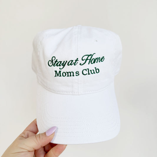 white classic baseball cap with stay at home mom embroidered in a fixed font design in a dark green thread.