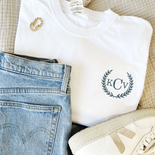 custom white comfort colors tee with a laurel framed custom embroidered monogram