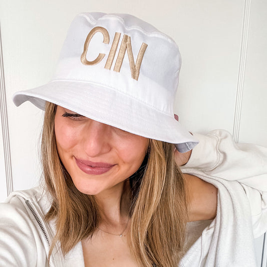 young woman wearing a personalized embroidered white bucket hat