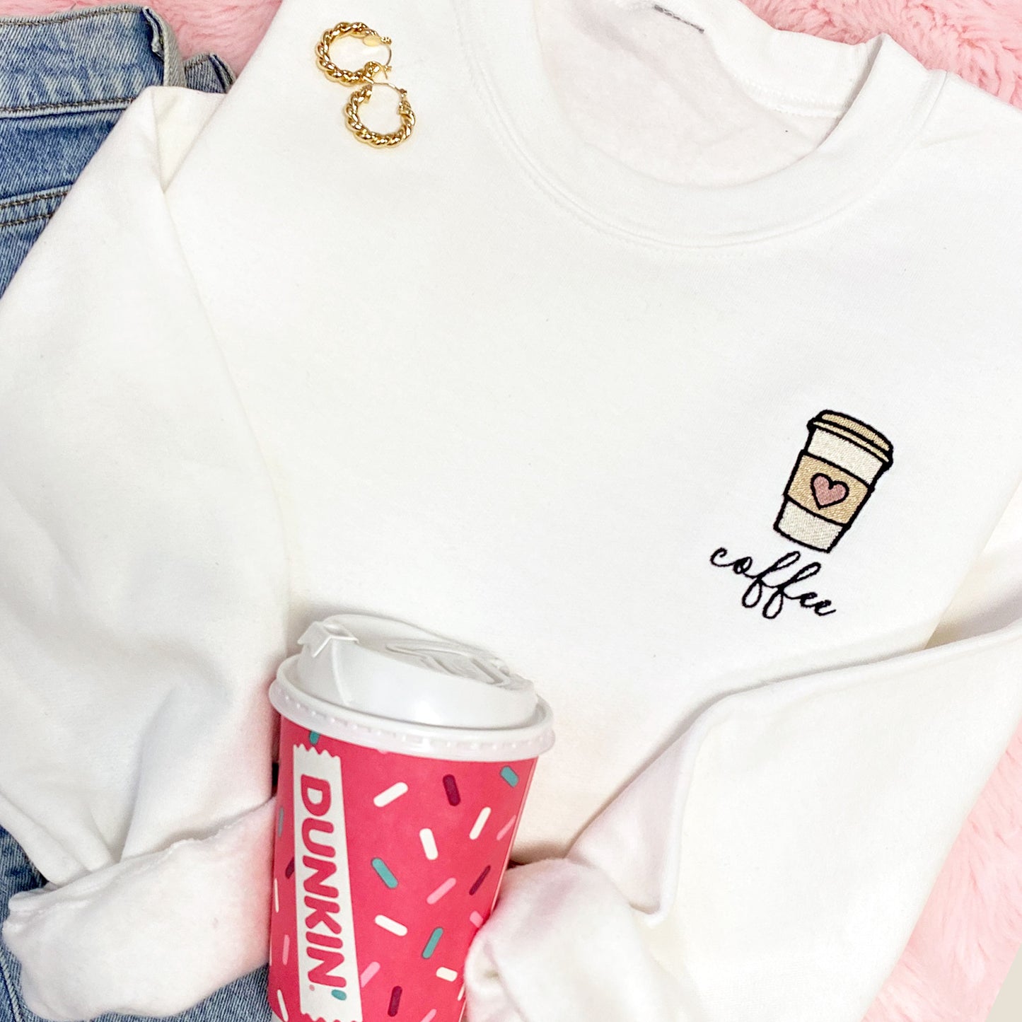 white crewneck sweatshirt with cute to-go coffee up embroidered design on the left chest