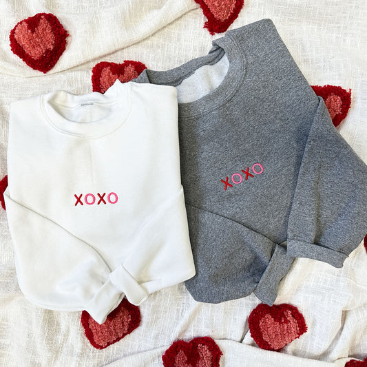 white and graphite heather crewneck sweatshirt with minimal xoxo embroidered design on the center chest