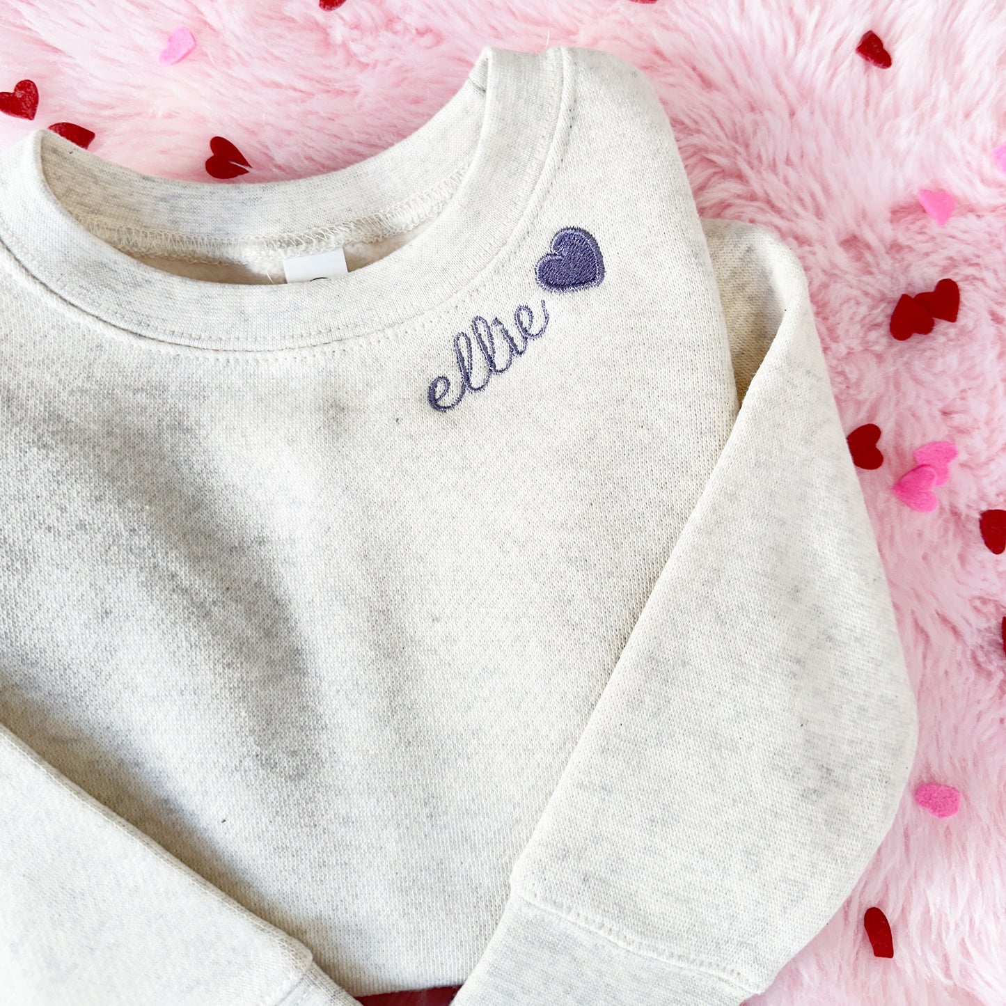toddler heather oatmeal sweatshirt with custom name and mini heart neckline embroidery