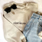 close up f styles sand crewneck sweatshirt with c'est la vie embroidered in script across the chest