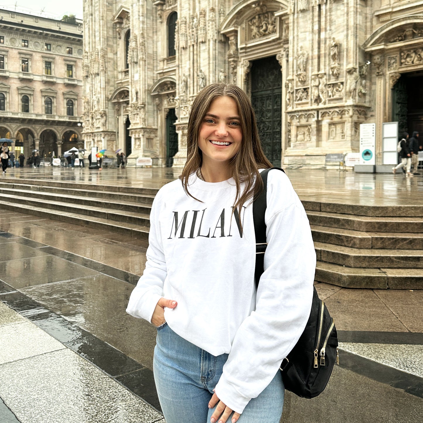 Woman wearing a printed Milan vogue type black and white sweatshirt