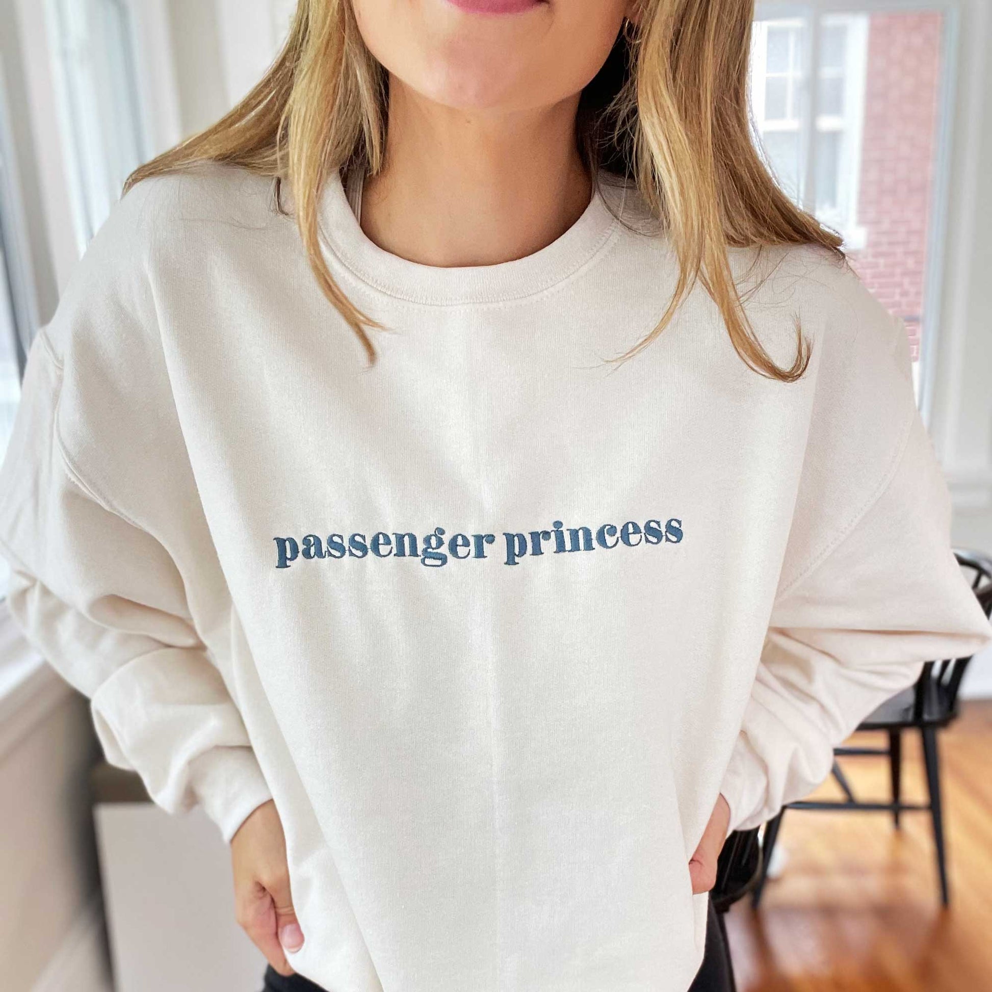 sweet cream crewneck sweatshirt with passenger princess embroidered in french blue thread