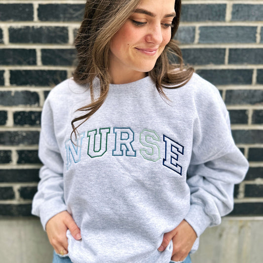Blue-Green Embroidered NURSE Athletic Block Gemma Top