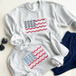 May include: Two gray sweatshirts with embroidered American flags. The flags are made of blue bows and red, white, and pink scalloped edges.