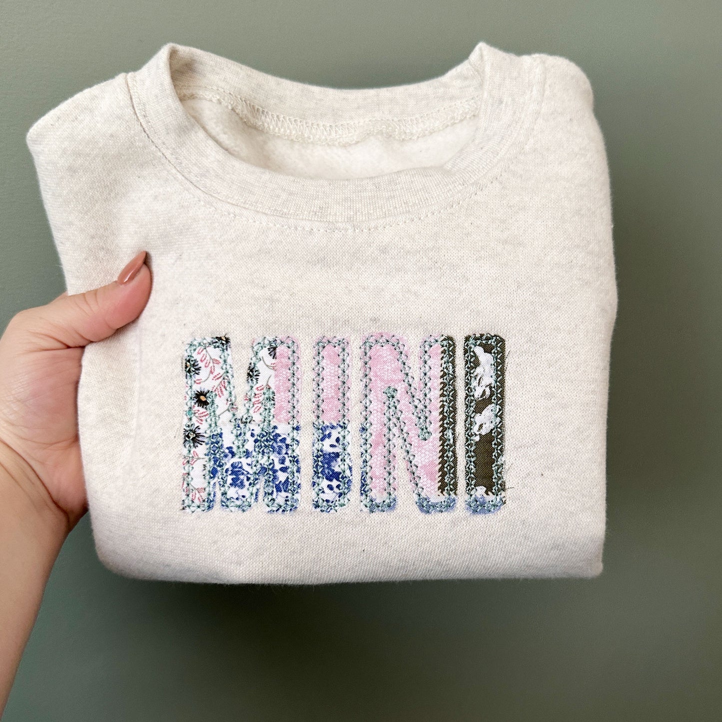 heather oatmeal youth crewneck with a custom MINI embroidered design over a vintage inspired patchwork fabric