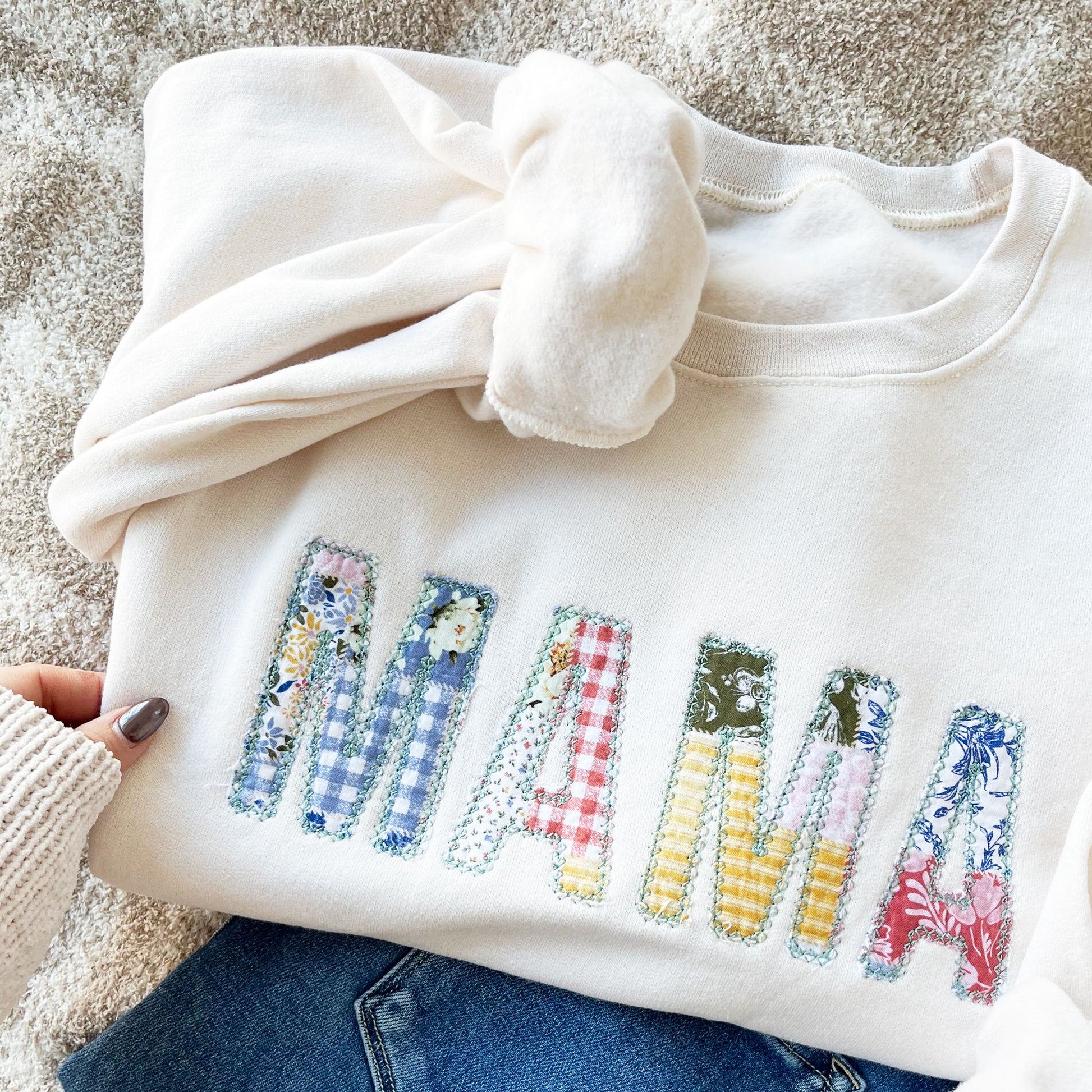 sweet cream crewneck sweatshirt with custom mama embroidered design featuring a vintage inspired patchwork quilted pattern with a raw edge for a homemade touch