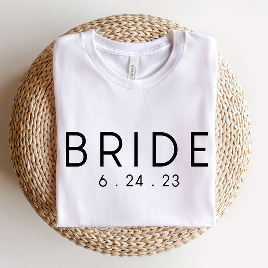 A white bella and canvas t-shirt with a custom BRIDE and wedding date DTG print 