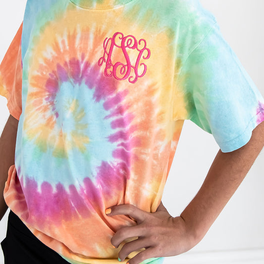 close up image of an embroidered monogram on a youth tie dye t-shirt