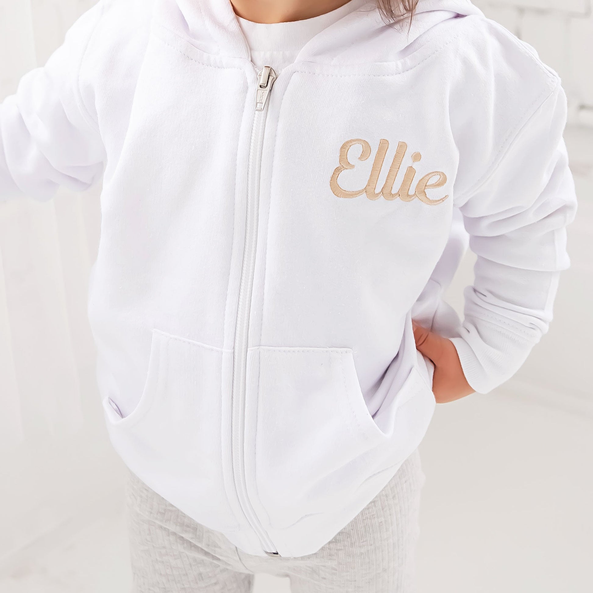 close up of a personalized name embroidery on a toddler hooded jacket