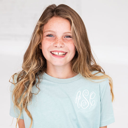 young girl wearing a bella and canvas t-shirt with a personalized monogram on the left chest