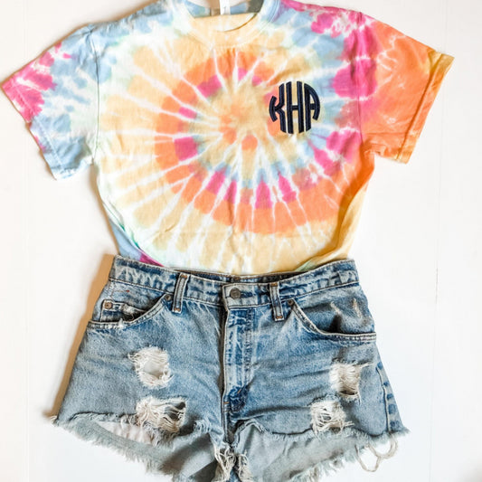 outfit layout featuring a pastel tie dye tee with custom monogram