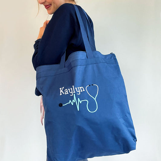 nurse holding tote with her name and stethoscope personalized on tote