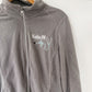 image of a light gray jacket on a hanger featuring a personalized embroidery design on the left chest for a registered nurse
