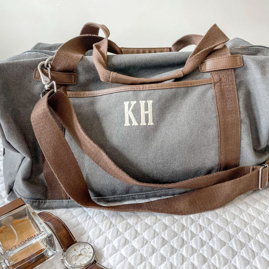 close up of gray bag with 2 letter monogram KH