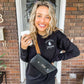 young woman on a front porch holding a Starbucks cup wearing a bella and canvas crewneck sweatshirt with embroidered ghost and spooky season design