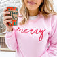 girl holding a starbucks coffee cup and wearing a light pink sweatshirt with a custom holiday embroidery across the chest in hot pink thread reading merry