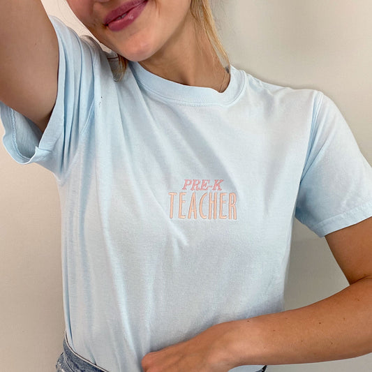 woman posing with grade level shirt 