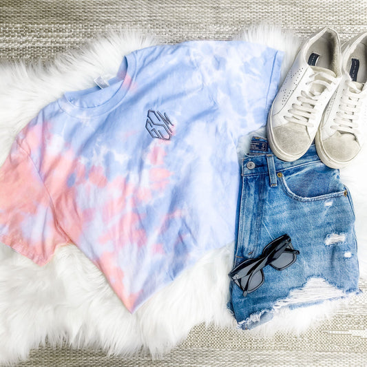 flatlay of outfit featuring coral and blue soft tie dye tee with personalized three letter monogram