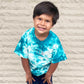 little boy wearing a teal tie dye tee with his name embroidered on the center of the t-shirt