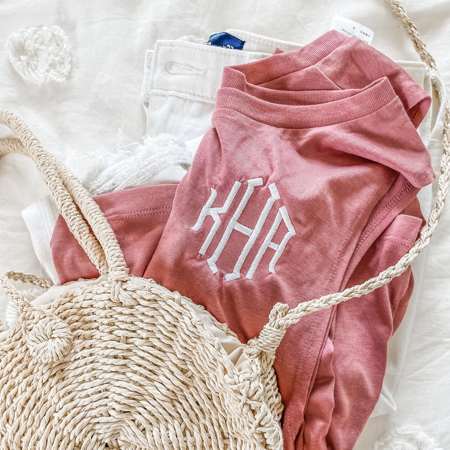 close up of three letter monogram embroidered on a pink bella ad canvas tank top