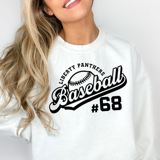 woman wearing an oversized white sweatshirt witha custom baseball team and number print across the chest