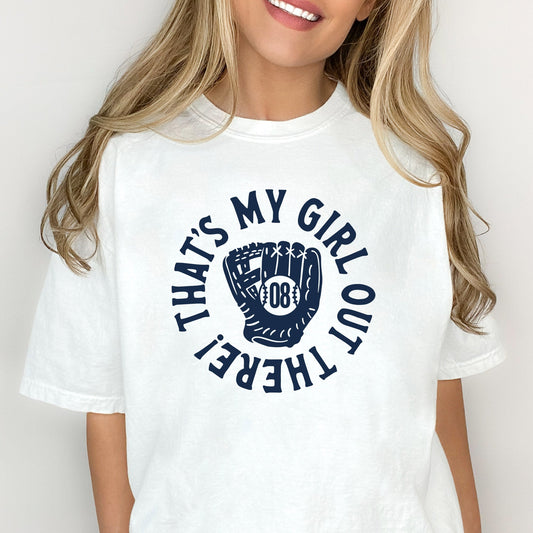 woman wearing a white t-shirt featuring a custom design reading 'that's my girl out there!' with a baseball mitt and custom player number in the center