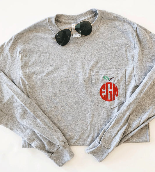 gray long sleeve top with a three letter apple monogram embroidered on the pocket