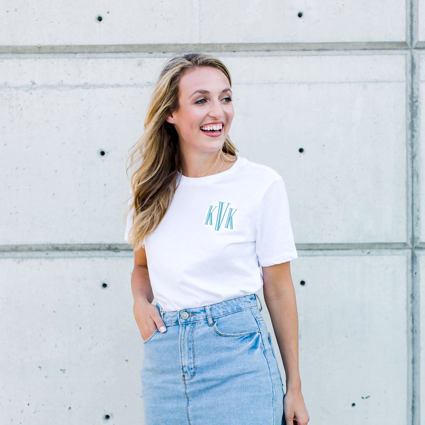 girl wearing a crewneck tee featuring a custom three letter embroidered monogram