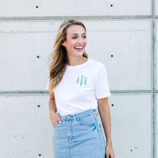girl wearing a crewneck tee featuring a custom three letter embroidered monogram